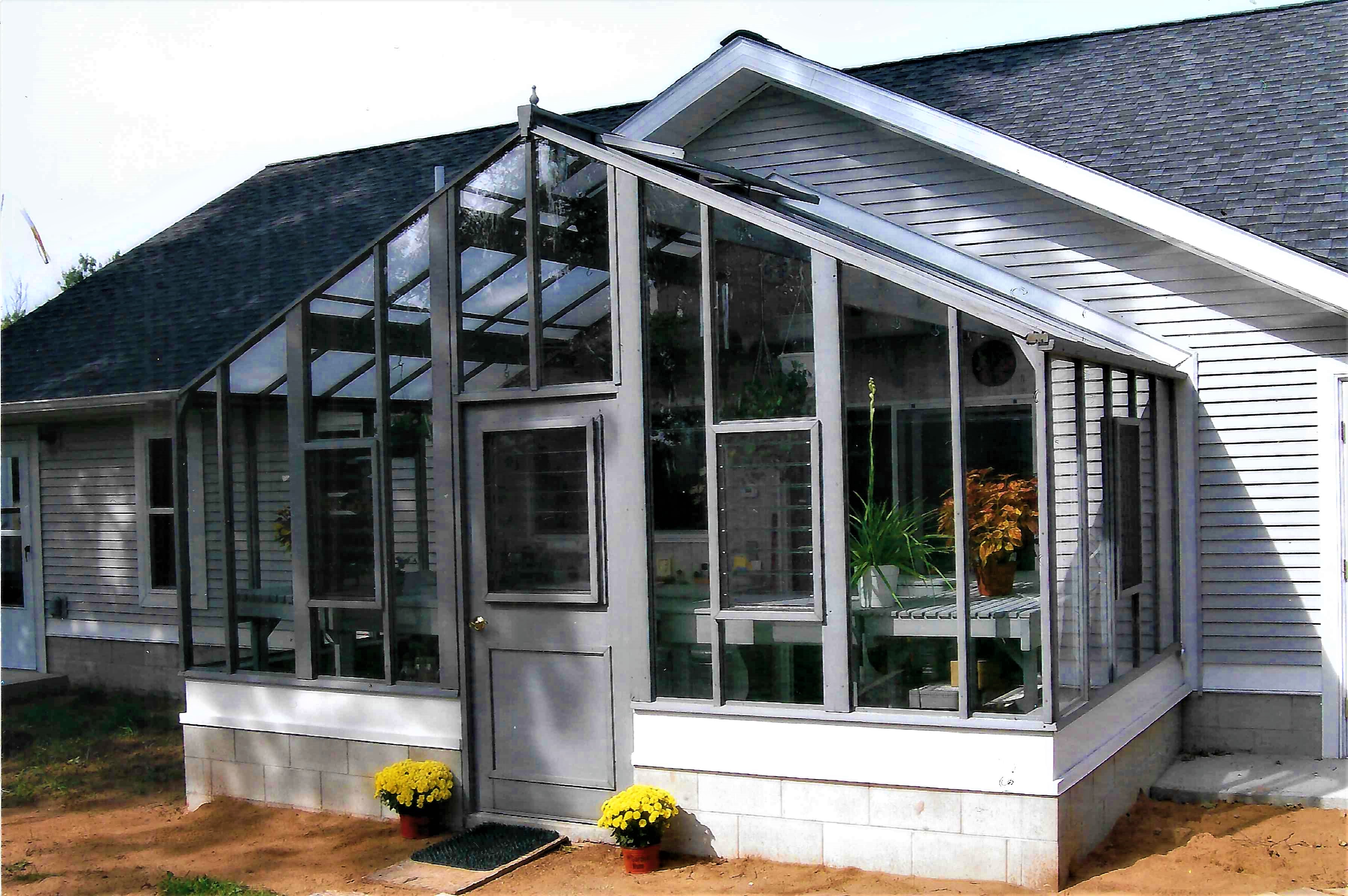 Attached 16' x 9' Deluxe Glass-to-Ground with Jalousie Windows in door and in end wall on 18" high block wall