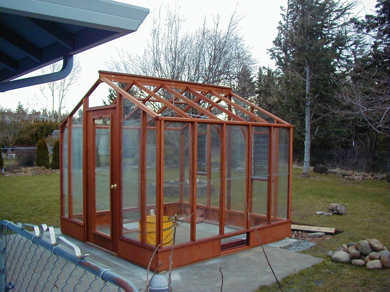 9x9 Deluxe Glass-to-Ground with two jalousie windows in back end wall and Full Lite door on 9.5" high Sturdi-Built base wall