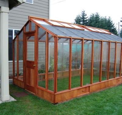 Door end view of 9x16 Deluxe Glass-to-Ground with Standard door on Sturdi-Built base wall