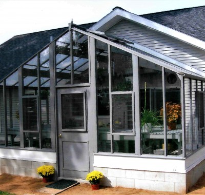 Attached 16' x 9' Deluxe Glass-to-Ground with Jalousie Windows in door and in end wall on 18" high block wall