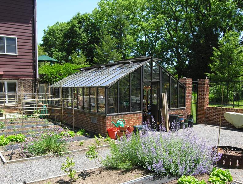 Painted redwood greenhouse on brick base