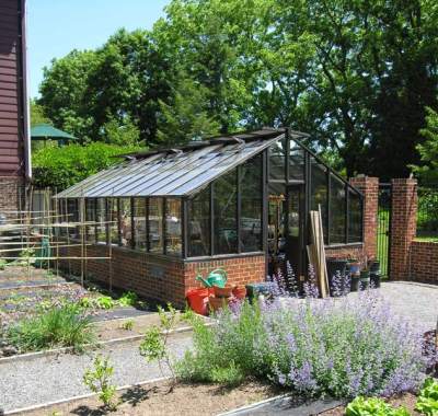 Painted redwood greenhouse on brick base