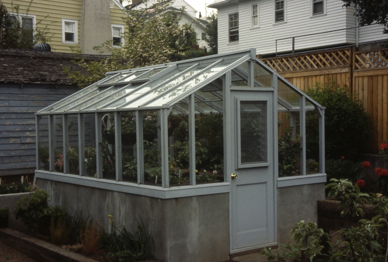 Redwood greenhouse on poured concrete wall