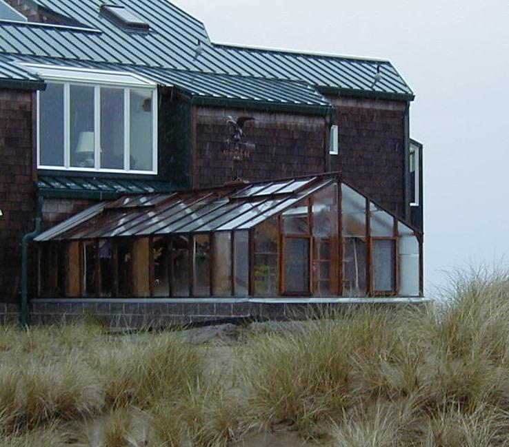 Coastal greenhouse attached at one end