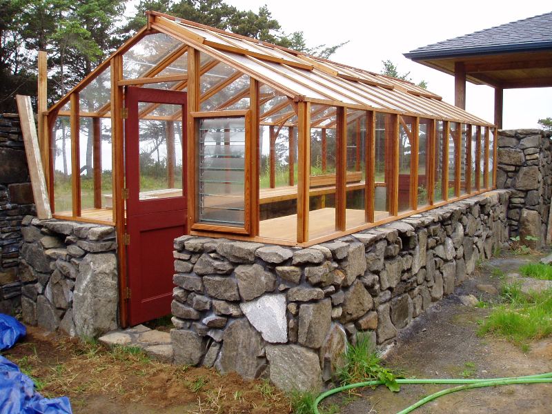 redwood greenhouse on stone base