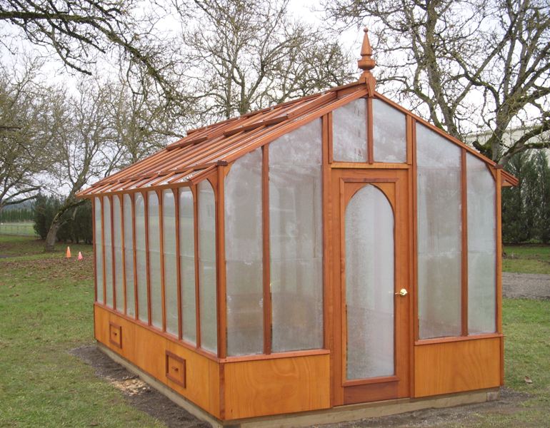 Tall redwood and glass greenhouse