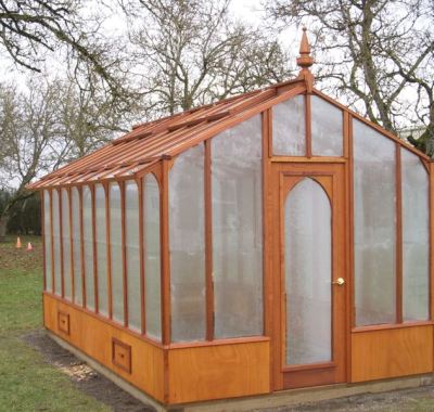 Tall redwood and glass greenhouse