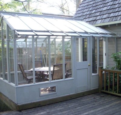 Tall glass greenhouse attached at one end