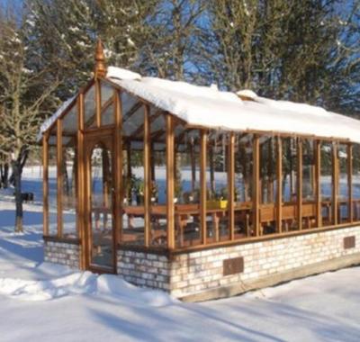 Tall redwood greenhouse in snow