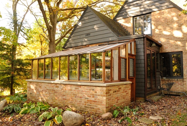 8x14 Garden Sunroom with jalousie windows for added ventilation set on a brick base wall to match home
