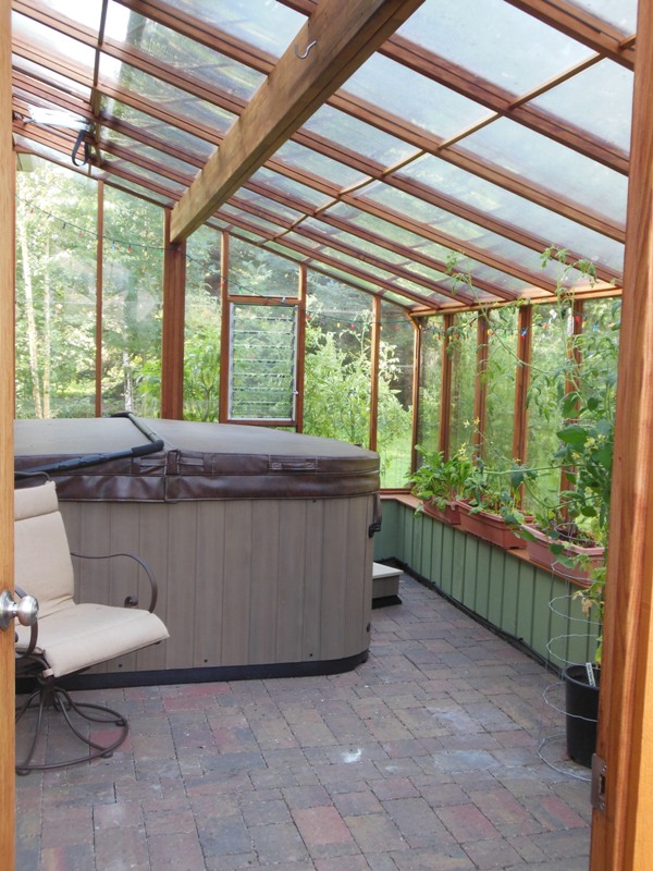 Interior of 9x18 Garden Sunroom greenhouse with hot tub