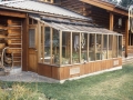 8x16 Garden Sunroom greenhouse attached to a log cabin
