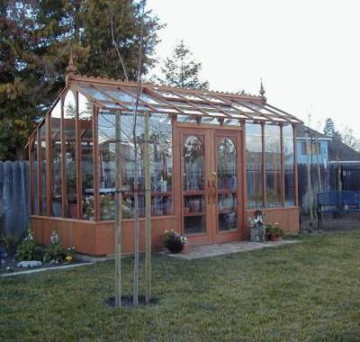Tall redwood and glass greenhouse