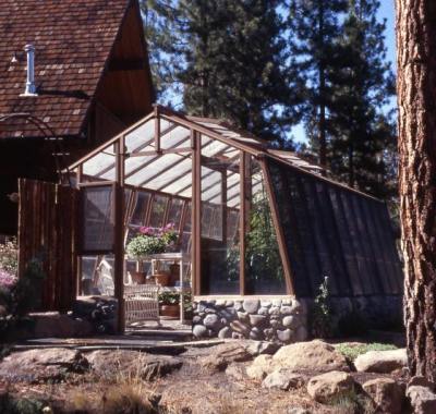 11ft wide Solite redwood greenhouse set on 18" rounded stone base wall