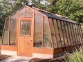 11x20 Solite redwood greenhouse with Jalousie window in the door and shade cloth on the roof