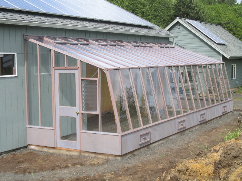 Large lean-to greenhouse attached to a barn