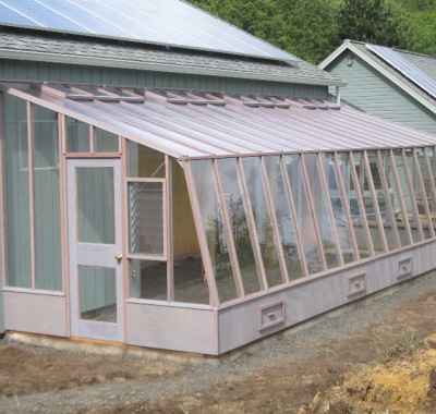 Large lean-to greenhouse attached to a barn