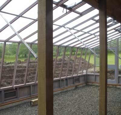 Interior of the 9x30 Solite Lean-to greenhouse with pipe beams and braces for roof support