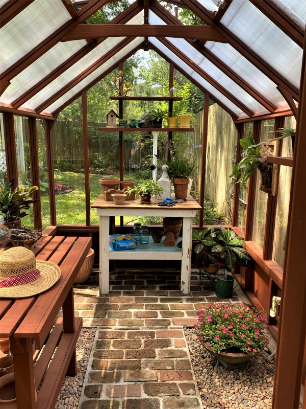 Interior of 7x11 Trillium garden greenhouse with benches and Twin Wall Polycarbonate roof