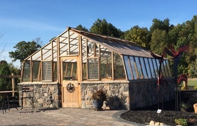 Redwood greenhouse on stone base