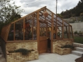 Large home greenhouse on brick base wall