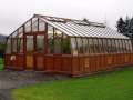 Large home redwood greenhouse with double doors