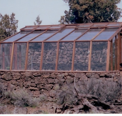 Lava rock base wall lean-to greenhouse
