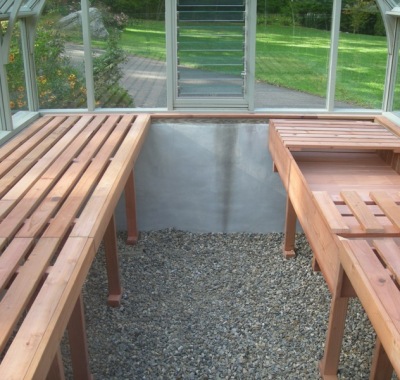Redwood greenhouse interior with garden bench