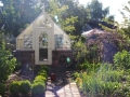 Tudor style garden greenhouse with brick base wall